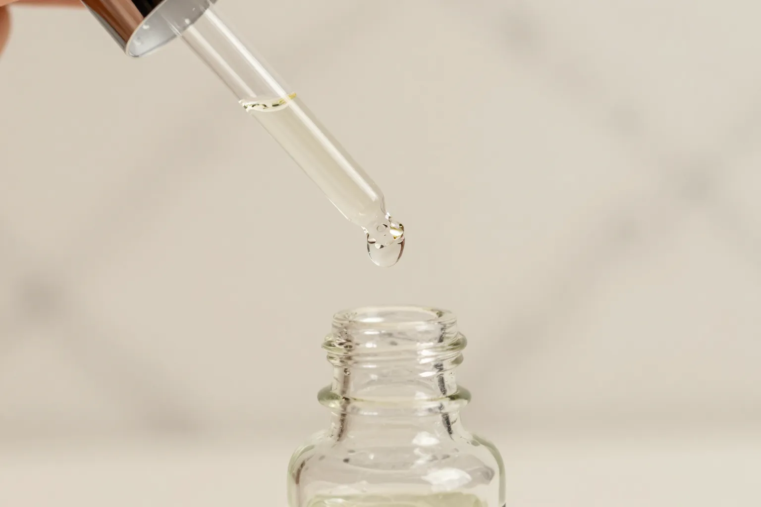 Peptide serum being applied to facial skin with visible plumping effect