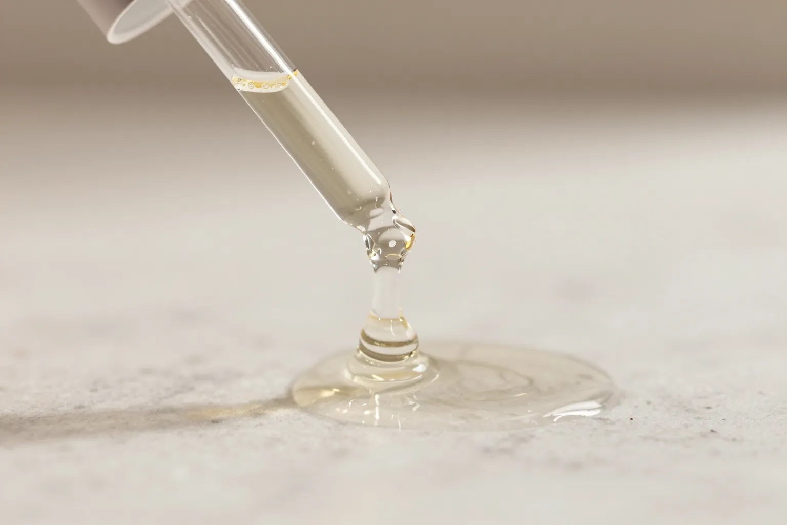 Close-up of snail mucin essence texture and consistency versus hyaluronic acid serum